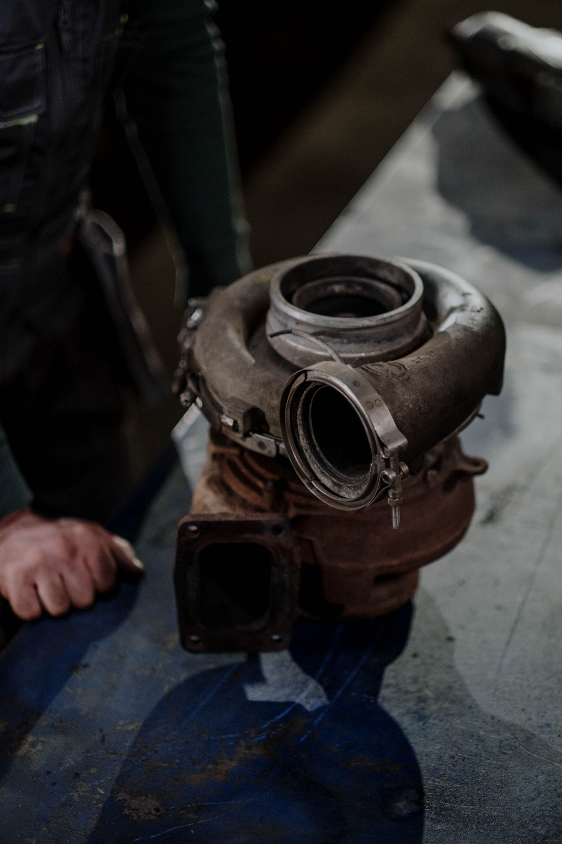 Worn turbocharger held in a workshop